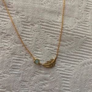 Jewlr gold tone necklace with feather or leaf and light blue stone